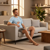 Sloth print pyjama set worn relaxing on a sofa in a warm living room
