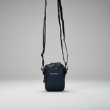 Small blue crossbody bag with visible brand name on a grey background