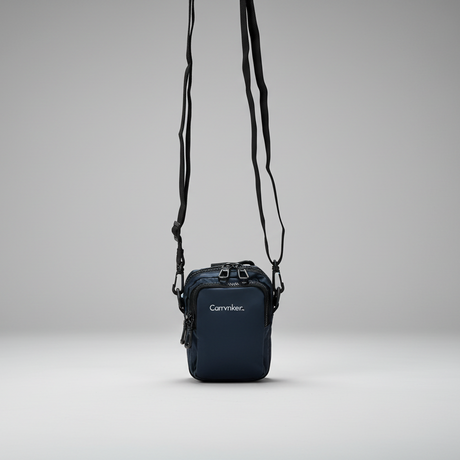 Small blue crossbody bag with visible brand name on a grey background