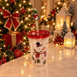 Clear straw tumbler with a snowman and gifts print, red lid and a penguin straw topper