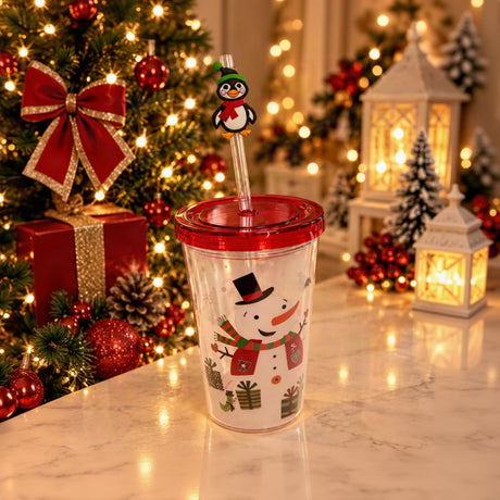 Clear straw tumbler with a snowman and gifts print, red lid and a penguin straw topper