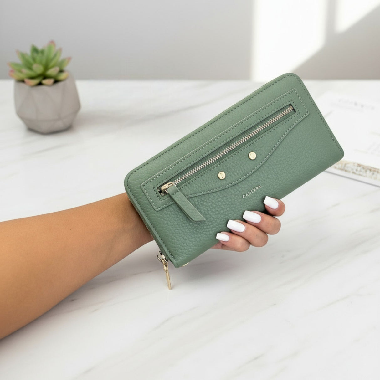 Green women's wallet with sleek zip design and gold accents