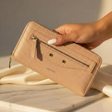 Pink women's wallet with sleek zip design and gold accents