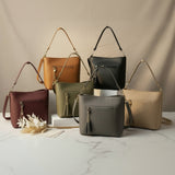 Six shoulder bags with front zip pockets and tassel charms in tan, black, burgundy, olive and beige