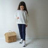 Cream sweatshirt with sparkle detail across the shoulders and hem