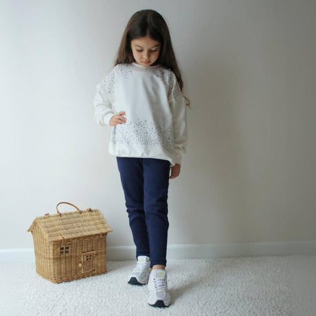 Cream sweatshirt with sparkle detail across the shoulders and hem