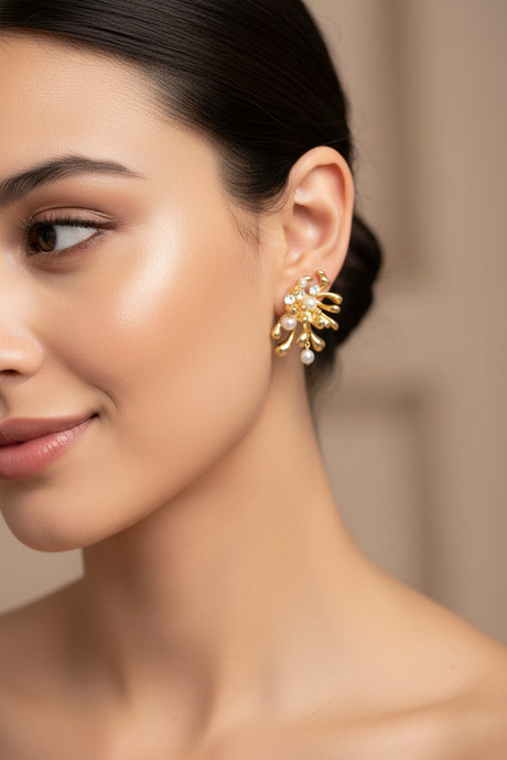 Woman wearing a gold earring with a blurred background