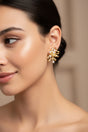 Woman wearing a gold earring with a blurred background