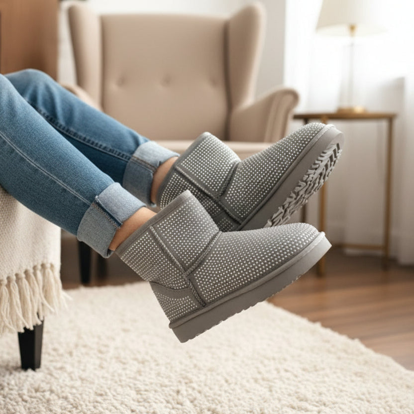 Gray studded boots worn with blue jeans in a home setting