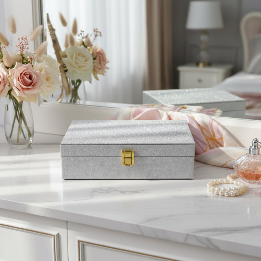Front view of the silver glitter jewelry box closed on a marble dresser