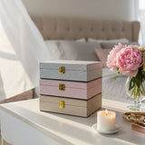 Silver, blush pink and champagne glitter jewelry boxes stacked with gold clasps