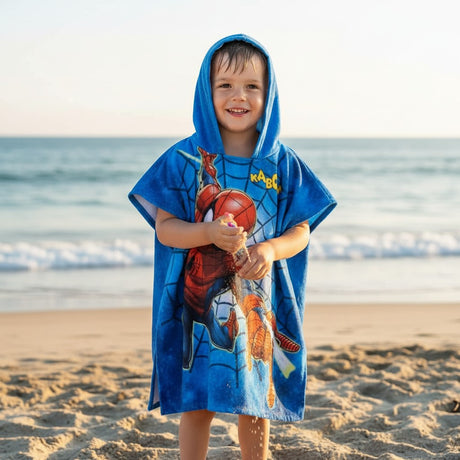 Boy wearing a blue Spider-Man hooded poncho towel on the beach – Jack Gifts Online Lebanon