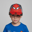 Young boy wearing a red and grey kids baseball cap with a masked superhero face and web print