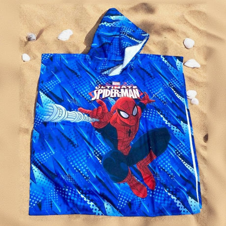 Cobalt blue Spiderman hooded poncho towel with a web slinging print flat lay on sand