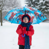 Boy in snow holding an open bright blue Spiderman kids umbrella with a red hero print