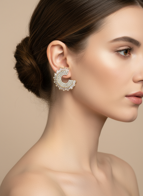 Close-up of a woman wearing a decorative spikey earring against a beige background