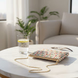Spot print tapestry bag on a marble side table beside a glass
