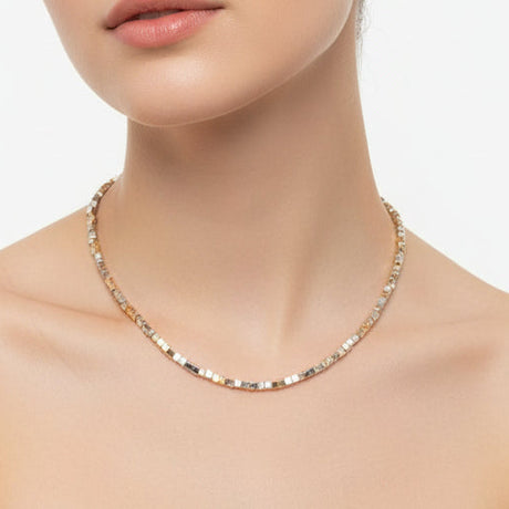 Woman wearing a square necklace on a white background