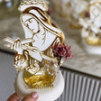 Veiled saint under a crown of thorns holding a crucifix, roses cut into her skirt