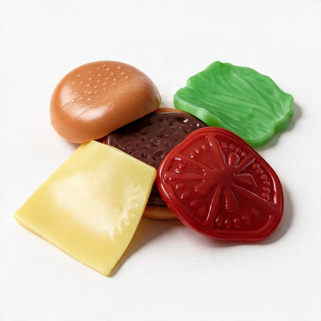 Burger squishy pieces laid out: bun, patty, cheese slice, tomato and lettuce