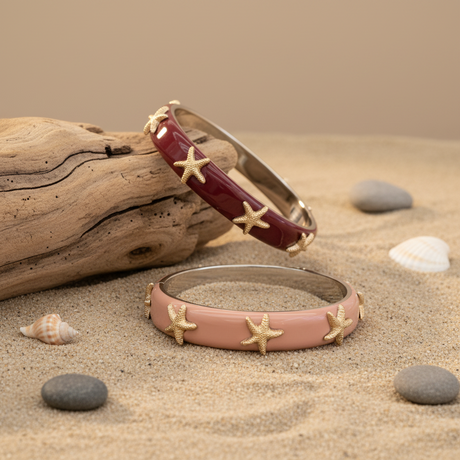 Two bangles with starfish designs on sand