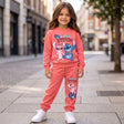 Girl in a coral stitch sweatshirt with matching coral joggers and white trainers