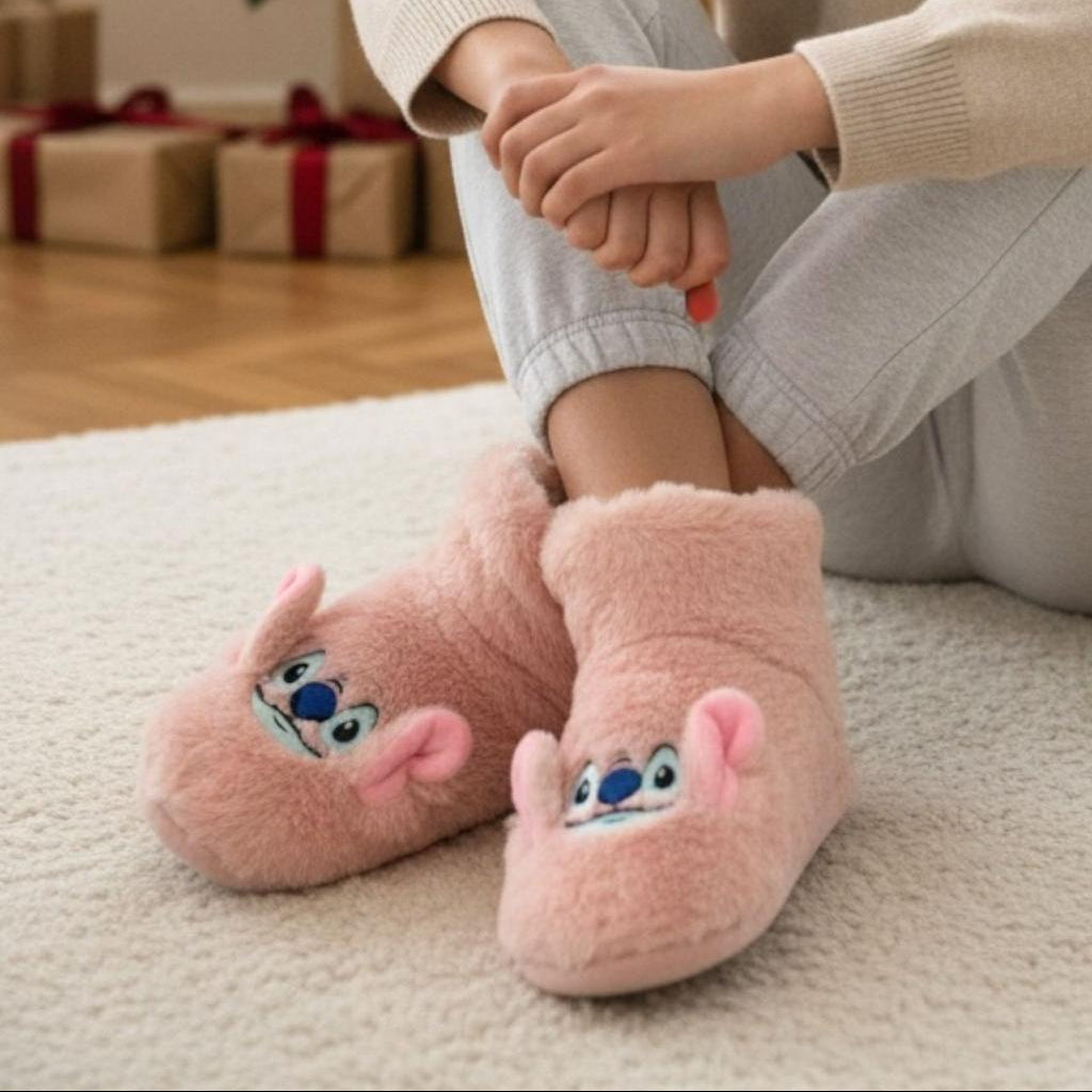 Person wearing pink stitch pantoufle on a carpeted floor with gift boxes in the background