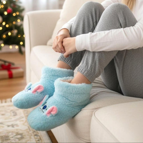 Person wearing blue stitch pantoufle with a Christmas tree in the background