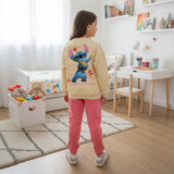 Back of a girls cream sweatshirt showing a large blue Stitch print above pink joggers