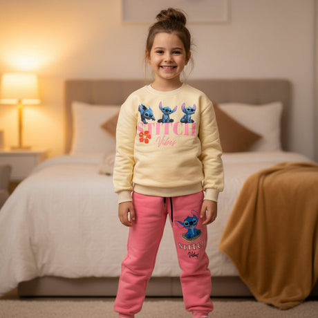 Front view of a cream Stitch sweatshirt with a pink flower graphic and matching pink joggers
