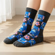 Kids blue and charcoal checkerboard crew socks with Stitch faces and pink flowers, worn standing