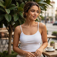 White ribbed crop cami with thin straps worn at a pavement cafe