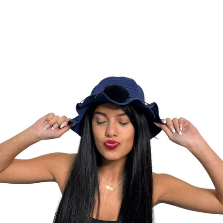 Navy wavy brim hat worn with both hands on the brim