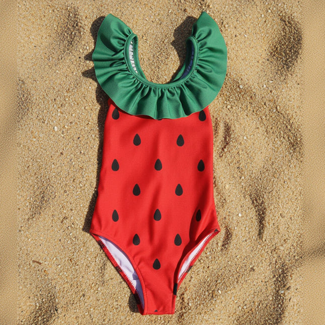 Strawberry-themed swimsuit with green top and red body with black seeds on a white background