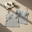 Two striped ribbed cami tops with button fronts in grey and white laid flat