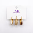 Three single striped enamel huggie earrings in white, beige and brown on a card