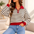 Woman in a cream and navy striped half zip sweater with a red collar, red cuffs and jeans