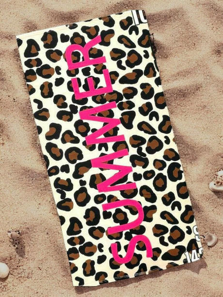 Leopard print towel with 'SUMMER' text in pink on a sandy background
