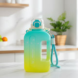 Gradient cyan and yellow summer water bottle with a strap on a kitchen counter