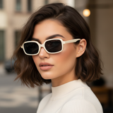 Woman wearing white sun chic sunglasses with a blurred background