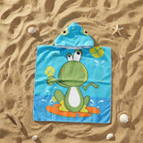 Aqua surfing frog poncho towel with printed frog eyes on the hood flat lay on sand