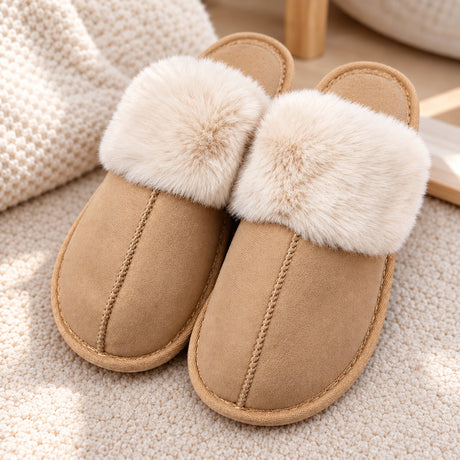 Tan suede look slippers with a fluffy cream fur collar and stitched seam on a knit rug