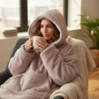 Taupe hooded blanket worn with the hood up showing the soft sherpa lining inside
