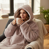 Taupe hooded blanket worn with the hood up showing the soft sherpa lining inside
