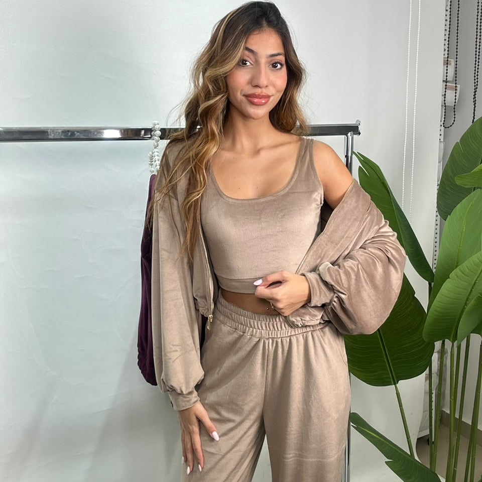 Taupe velvet jacket slipped off one shoulder showing the matching scoop neck crop top