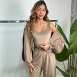 Taupe velvet jacket slipped off one shoulder showing the matching scoop neck crop top
