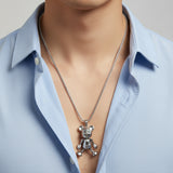 Silver jointed teddy bear pendant on a box chain over a blue shirt, Jack Gifts Online Lebanon