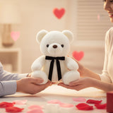 White bow bear passed between a man's hand and a woman's hands over a bright table
