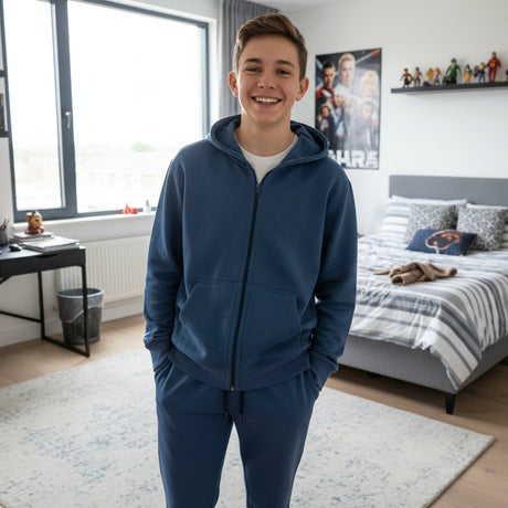 Teen boy in a denim blue zip up hooded jacket with matching blue joggers in a bedroom