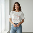 Thank you script printed in pink across a white tee